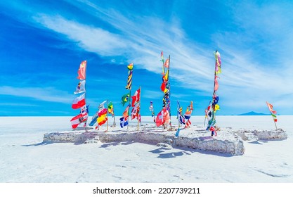 Flags of all participating countries at the Dakar monument on the Salar de Uyuni salt flats in Bolivia.