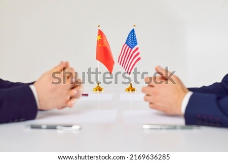 Flags of America and China atand on table during talks between diplomats and businessmen. American and Chinese representatives sit opposite each other to discuss relations between countries. Stock photo © 