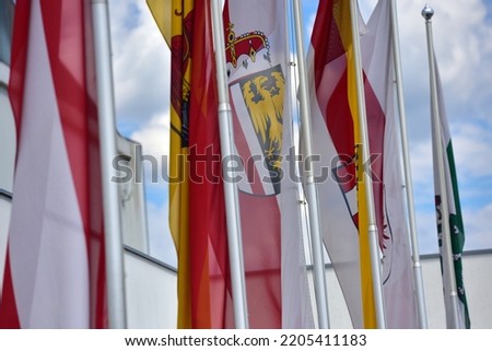 Flags of the Austrian federal states in front of a fair hall