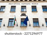 Flags of Bulgaria and the European Union on the facade of the Bulgarian National Bank in Sofia, Bulgaria. The inscription on the wall "Bulgarian National Bank"