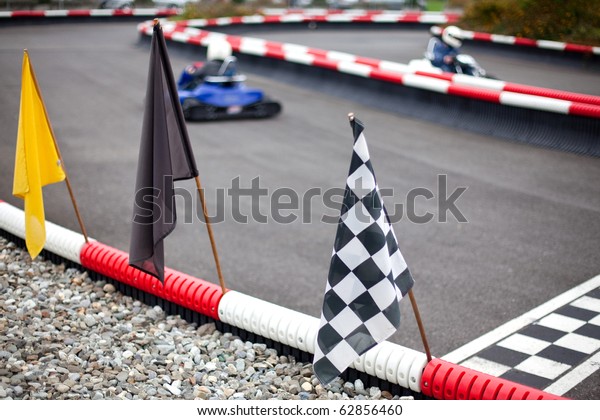 flags and cars on carting\
track