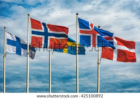 The flags of the countries of Scandinavia waving in the sky of a beautiful summer day.