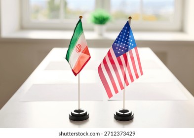 Flags diplomacy meeting on table symbolize negotiations. Iran and United States at conference table; dialogue, agreement, conflict. Represents international relations and diplomatic dialogue.
