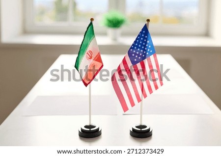 Flags diplomacy meeting on table symbolize negotiations. Iran and United States at conference table; dialogue, agreement, conflict. Represents international relations and diplomatic dialogue.