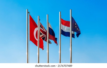 Flags Of The European Union - EU, Netherlands, Turkey, Great Britain And Russia Against The Blue Sky. Empty Flag.