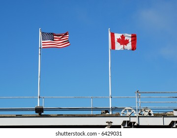 Flags Flying At A US And Canadian Border