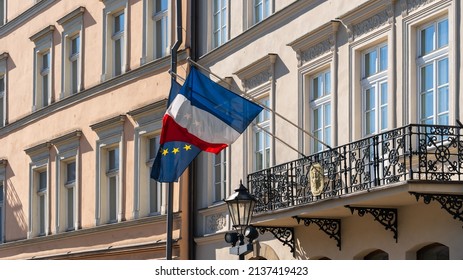 The flags of France and the European Union flutter in the wind on the old wall of the French consulate in a European city on a sunny day - Shutterstock ID 2137419423
