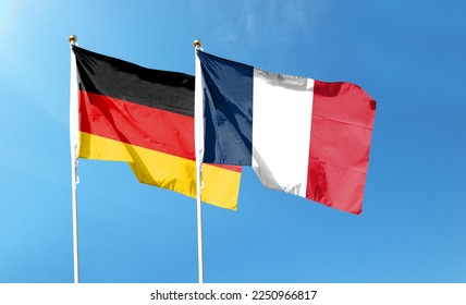 Flags of France flag and Germany flag against cloudy sky. waving in the sky - Shutterstock ID 2250966817