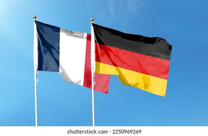 Flags of France flag and Germany flag against cloudy sky. waving in the sky - Shutterstock ID 2250969269