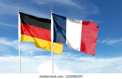 Flags of France flag and Germany flag against cloudy sky. waving in the sky - Shutterstock ID 2250982397