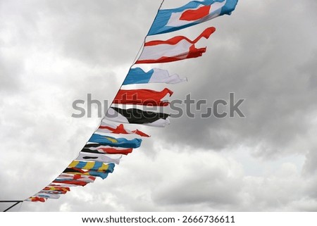 Flags of the International Code of Signals against the cloud sky
