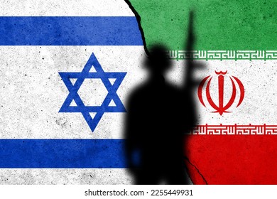 Flags of Israel and Iran painted on the concrete wall with soldier shadow.