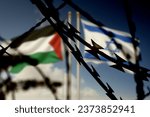 Flags of Israel and Palestine and barbed wire