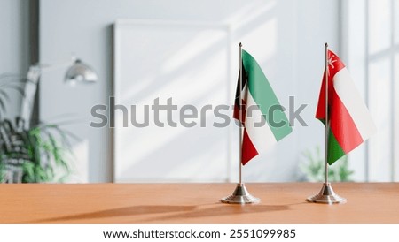 FLAGS OF KUWAIT AND OMAN ON TABLE