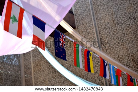 Flags of many countries, including UK, put together on a string in an international conference