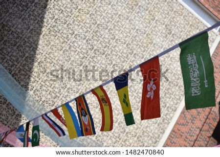 Flags of many countries, put together on a string in an international conference