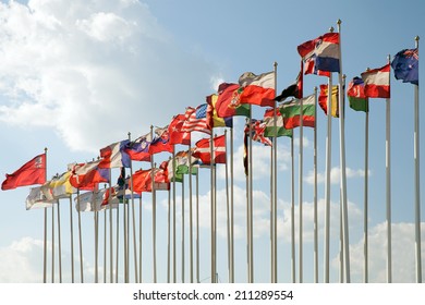 Flags Of Many Nations Of The World Are Flying In Blue Sunny Sky