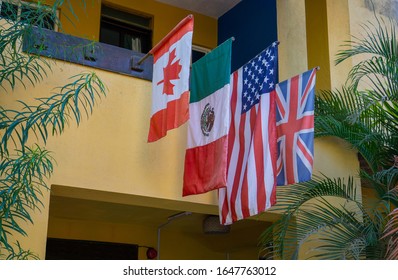 Flags Of Mexico, Canada, United States And England On The Facade Of A Mexican House.