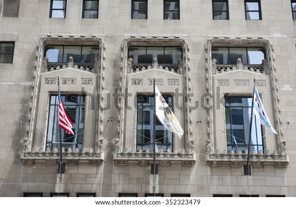 Flags on\
the Chicago Tribune Tower building in Chicago. Chicago Tribune\
tower is a tall skyscraper in Chicago, which is home to Chicago\
Tribune, Tribune Publishing and Tribune\
Media.