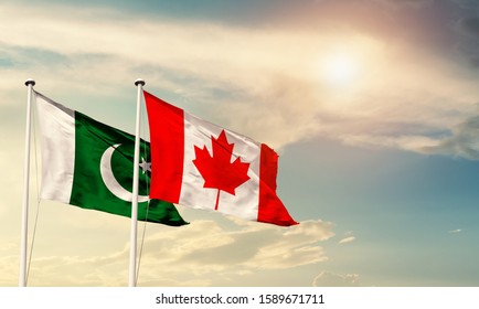 Flags of Pakistan and Canada friendship flag waving on the sky with beautiful sun light - image - Shutterstock ID 1589671711