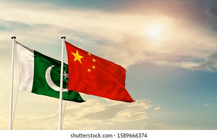 Flags of Pakistan and China friendship flag waving on the sky with beautiful sun light - image - Shutterstock ID 1589666374