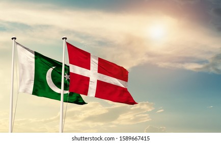 Flags of Pakistan and Denmark friendship flag waving on the sky with beautiful sun light - image - Shutterstock ID 1589667415