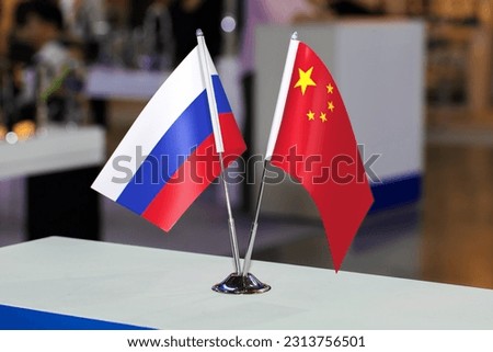 Flags of Russia and China together at some event or fair. The flags of the two countries as a symbol of cooperation between the two states. Joint business of Russia and China