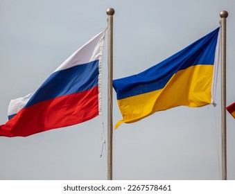 Flags of Russia and Ukraine against the sky. Symbol - Shutterstock ID 2267578461
