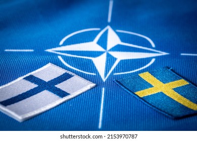 Flags of Sweden and Finland against the background of the symbol of NATO, the Defense Organization, The concept of extending the borders of the alliance new Scandinavian countries, 9 May 2022