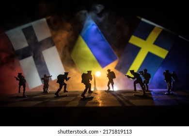 Flags of Sweden, Finland and Ukraine on dark background. Conceptual image of war between Russia and countries using toy soldiers and national flags . Selective focus - Powered by Shutterstock