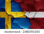 flags of Sweden and Latvia painted on cracked wall