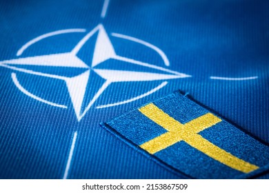 Flags of Sweden and the symbol of NATO, The largest defense alliance in the world, The concept of extending the borders of the North Atlantic alliance with the new Scandinavian countries, May 2022