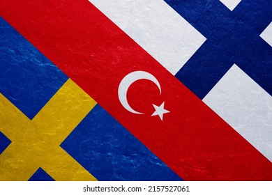 Flags of Turkey, Sweden and Finland on a concrete wall