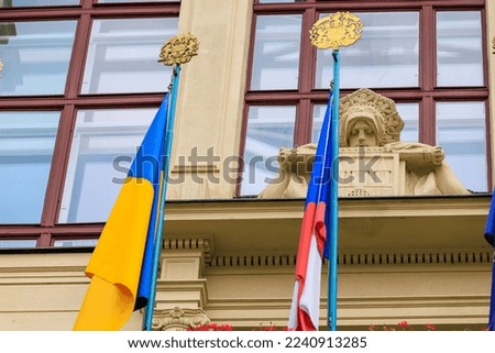 Flags of Ukraine and the Czech Republic on a historic building in Prague. European support for Ukrainian refugees