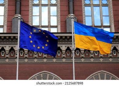 Flags of Ukraine and European Union in Kiev. Yellow-blue state Ukrainian and European Union flags in Kyiv, near  National Bank, Independence Constitution Day, National holiday.