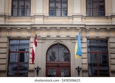 Flags of Ukraine and Latvia waiving together in Riga, Latvia, to show solidarity from the Latvians to ukrainians during the war in Ukraine against Russia. - Powered by Shutterstock