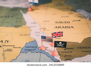 Flags of the United States and United Kingdom surrounding a pirate insignia onto a map of the Red Sea region. vertical video. It symbolically represents the intricate geopolitical dynamics and