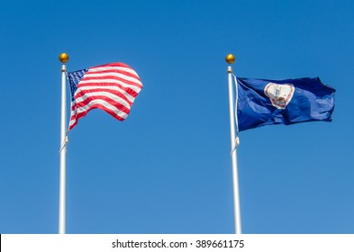 The flags of the United States and Virginia on poles during windy weather taken at the University of Virginia
