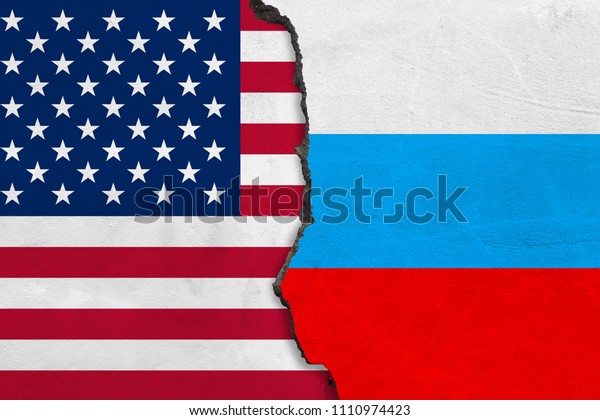 Flags of USA
and Russia painted on cracked
wall