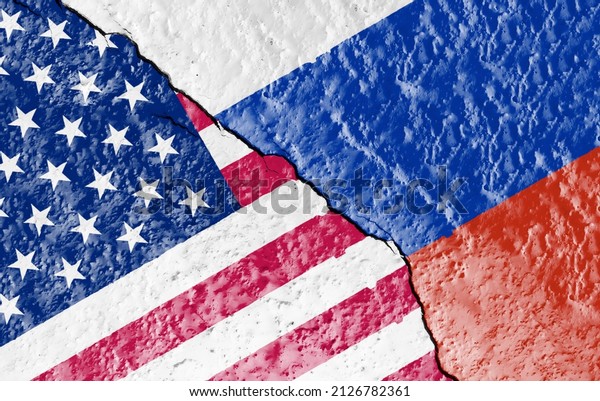 the\
flags of the USA and Russia painted on a ruined wall and divided by\
a diagonal crack. International diplomatic\
relations.