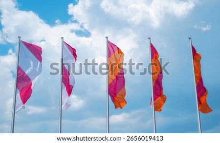 flags waving in the wind against cloudy sky