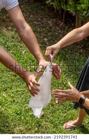 A flag-stealing game action with the hands of two players trying to grab the flag