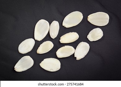 Flaked Almonds Scattered Over Black Slate.  Overhead View.