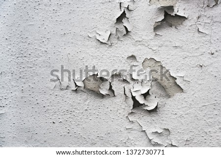 flaking gray paint on an old building, background texture for renovation concept, copy space