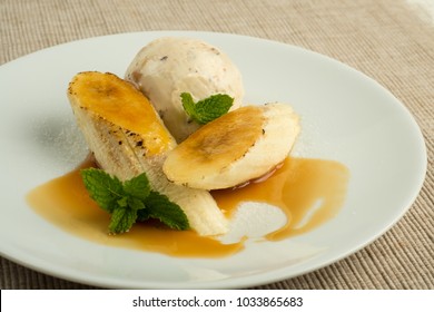 Flambe Banana with butter rum ice cream with caramel sauce