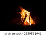 flame of a bonfire burning at night, burning mainly wood, traditional bonfire in the wind, campfire, bushcraft