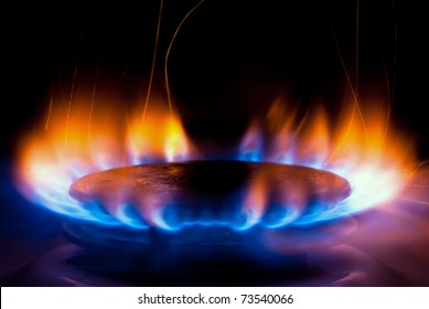 a flame burning on a gas stove in the kitchen