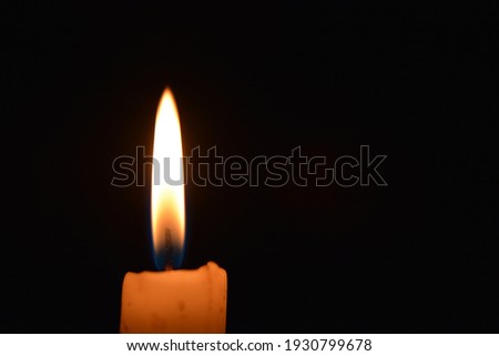 Flame candle isolated on black background. Close up.