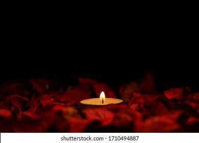 The flame of a candle in a red petal - Powered by Shutterstock