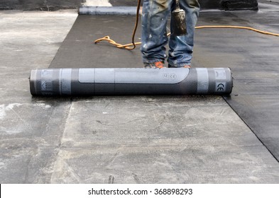 flame during welding of a waterproofing membrane on a roof - Shutterstock ID 368898293